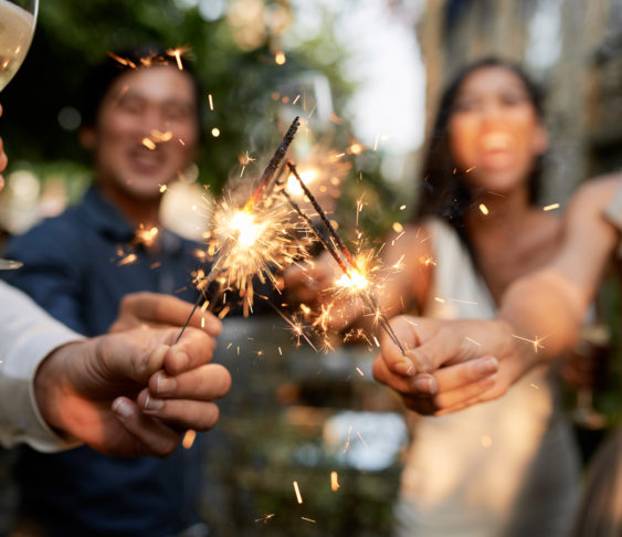 Image of people burning sparklers outside
