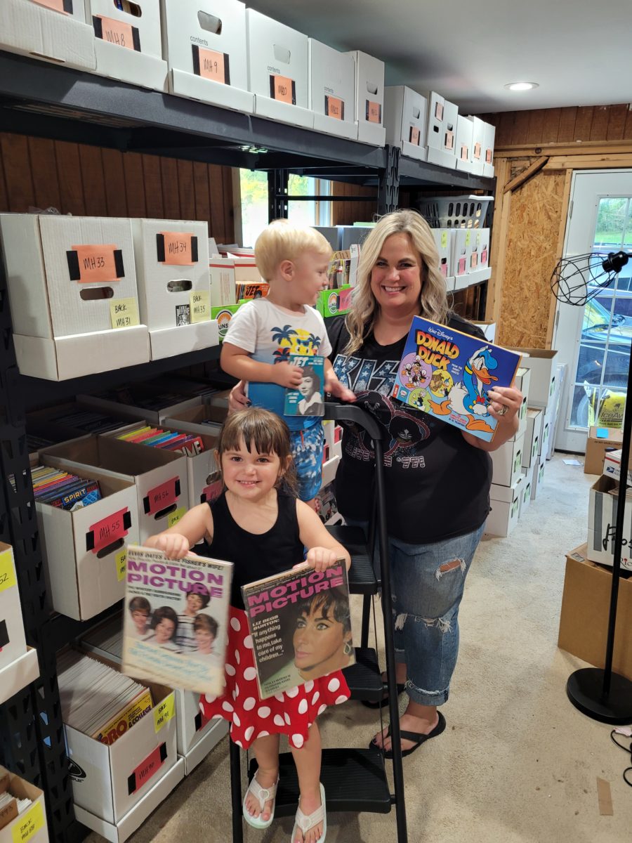 eBay seller Matt's wife, daughter and son posing with collectibles magazine collection.