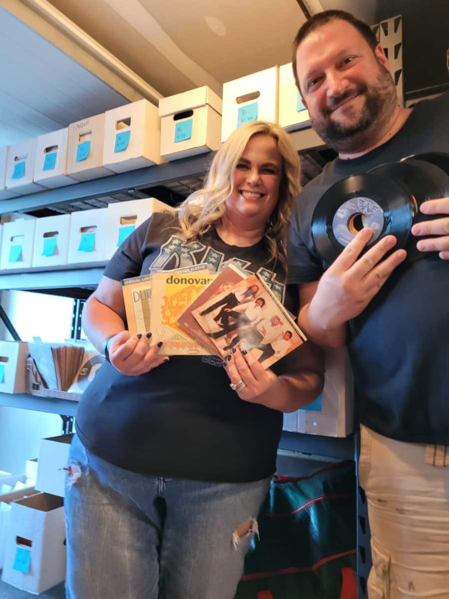 eBay seller Matt and his wife posing with collectibles vinyl records in hand.